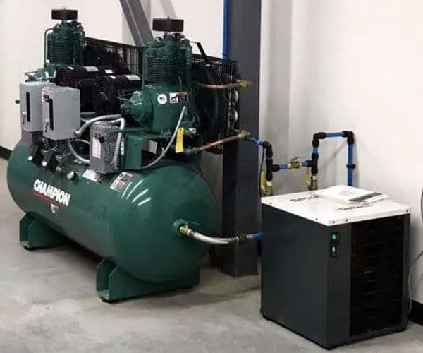 Industrial air compressor setup in a workshop.