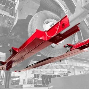 Red car lift platform under vehicle wheel